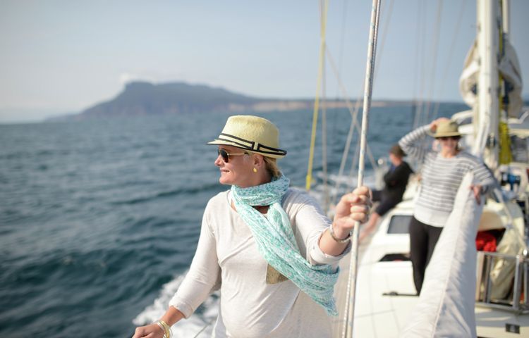 Guest overlooking the ocean on yacht in Wineglass Bay