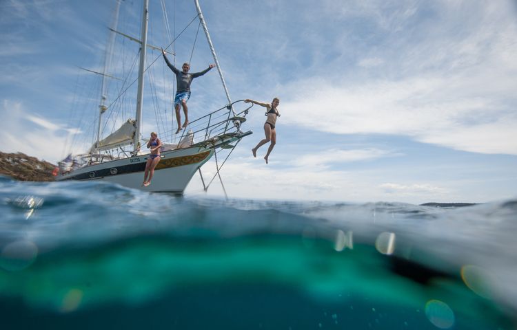 Guests jumping off the sailboat into Wineglass Bay