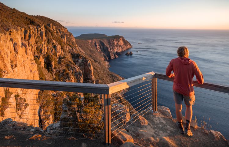 Guest at Crescent Lodge overlooking cliff faces
