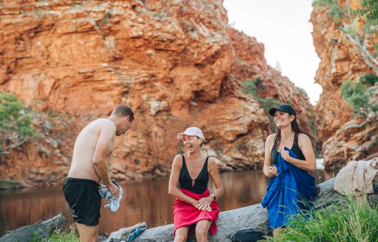 guests enjoying swim at waterhole on Larapinta walk