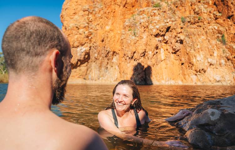 Guests swimming in waterhole on Larapinta Trail