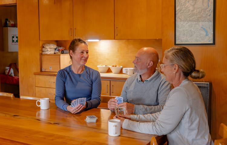 Guests sitting at table in Cradle mountain huts accommodation