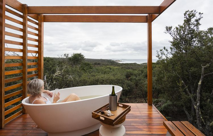 Guest relaxing in Bubble bath overlooking nature