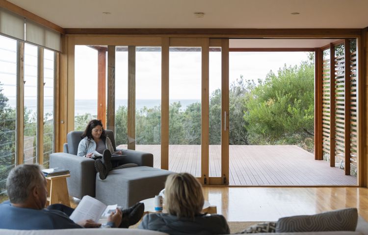 Guests sitting, relaxing on couch at Bay of Fires