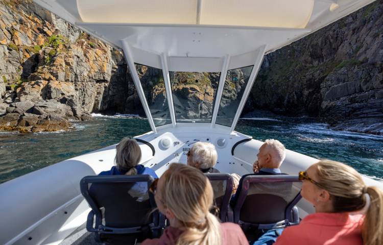 Guests riding on boat in Bruny island walk