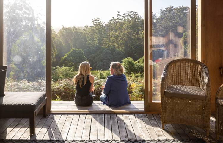 Guests sitting on the balcony at Bruny Island Lodge