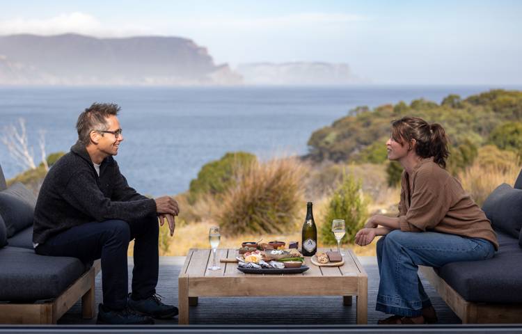 Guests relaxing and dining on the Three Capes Walk